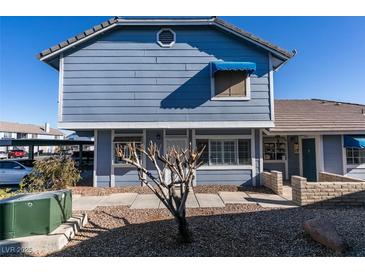 Charming two-story home featuring a light blue exterior, well-kept landscaping, and a covered carport at 5340 Silvermist Ct # 103, Las Vegas, NV 89122