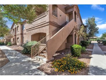 Tan two-story building with stairs and landscaping at 5751 E Hacienda Ave # 232, Las Vegas, NV 89122