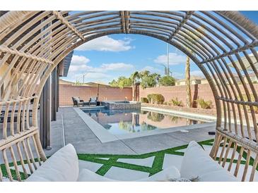 Inviting backyard with sparkling pool, spa, and relaxing seating area at 6456 Grande River Ct, Las Vegas, NV 89139