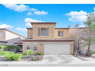 Two-story house with beige exterior, shutters, and a two-car garage at 7490 Thistle Poppy St, Las Vegas, NV 89139