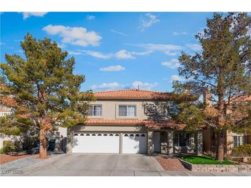 Two-story house with a three-car garage and landscaping at 8600 Copper Falls Ave, Las Vegas, NV 89129