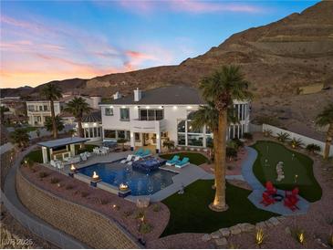 Luxury home with pool and putting green; sunset view at 1610 Hardrock St, Las Vegas, NV 89156