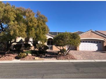 Single-story house with a two-car garage and landscaped front yard at 1736 Williamsport St, Henderson, NV 89052