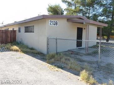 Ranch style home with a carport and chain link fence at 2139 Crawford St, North Las Vegas, NV 89030