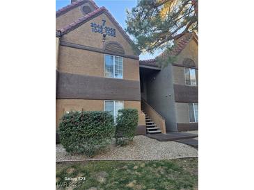 Tan two-story building with shrubs and stairs at 2200 S Fort Apache Rd # 2050, Las Vegas, NV 89117