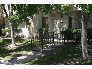 Front view of condo with gated entry and landscaping at 2616 Aracatuba Ave, Las Vegas, NV 89121