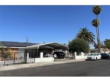 Single story home with carport, solar panels, and fenced yard at 3712 San Joaquin Ave, Las Vegas, NV 89102