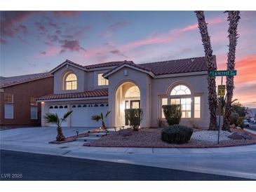 Two-story house with a three-car garage and landscaped front yard at 3925 Larkcrest St, Las Vegas, NV 89129