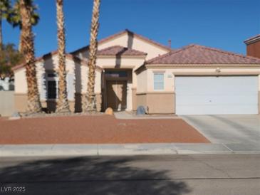 Single-story house with a two-car garage and desert landscaping at 414 Maritocca Ave, North Las Vegas, NV 89031