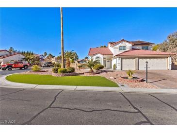 Two-story house with landscaped yard, driveway, and attached garage at 5112 Palm View Dr, Las Vegas, NV 89130