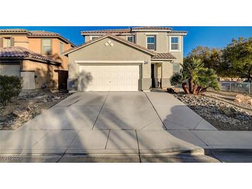 Two-story house with a large driveway and desert landscaping at 6104 Talbot Springs Ct, North Las Vegas, NV 89081