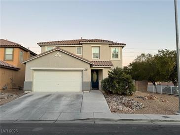 Two-story house with attached garage and landscaped front yard at 6104 Talbot Springs Ct, North Las Vegas, NV 89081