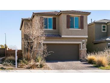 Two-story house with brown garage door and landscaped front yard at 7122 Rocket Launch St, North Las Vegas, NV 89084