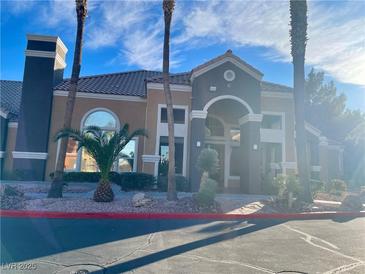 Tan building exterior with palm trees and landscaping at 8101 W Flamingo Rd # 1112, Las Vegas, NV 89147