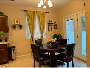 Bright dining area with a round table and four chairs, near the kitchen at 8157 Amy Springs St, Las Vegas, NV 89113