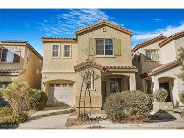 Two-story house with tan siding, attached garage, and landscaping at 8157 Amy Springs St, Las Vegas, NV 89113