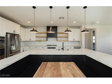 Modern kitchen with stainless steel appliances and large island at 8224 Skye Territory St, Las Vegas, NV 89166