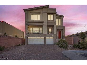 Modern three-story home with two-car garage and landscaped front yard at 9045 Knots Estate St, Las Vegas, NV 89139