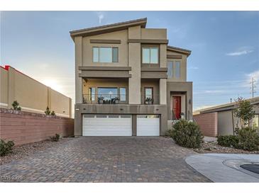 Modern three-story home with two-car garage and landscaped front yard at 9045 Knots Estate St, Las Vegas, NV 89139