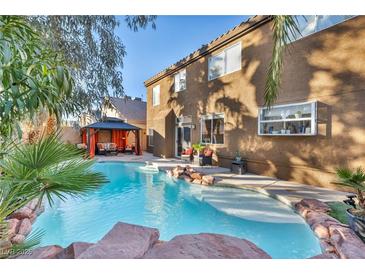 Inviting backyard oasis with a sparkling pool, gazebo, and lush landscaping at 9131 Sangria Ln, Las Vegas, NV 89147