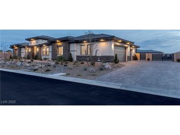 Beautiful single-story home featuring stone accents, manicured landscaping, and a paved driveway at 9525 Ponderay Ct, Las Vegas, NV 89149