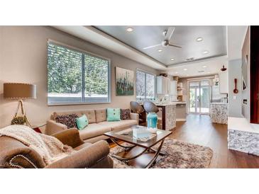 Bright living room with hardwood floors, comfortable seating, and an open floor plan at 1036 Novara Ln, Las Vegas, NV 89144