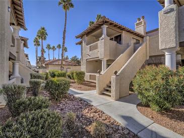 Spanish style condo building with walkway and landscaping at 1409 Santa Margarita St # G, Las Vegas, NV 89146