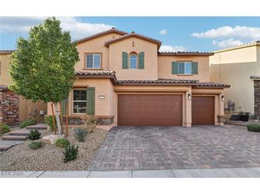 Two-story house with a three-car garage and landscaped front yard at 1557 Mistywood Ct, Henderson, NV 89014