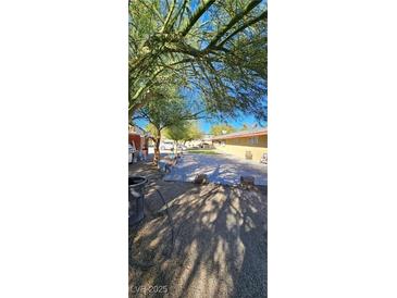 Spacious backyard with paved patio and mature trees at 2600 E Bonanza Rd, Las Vegas, NV 89101