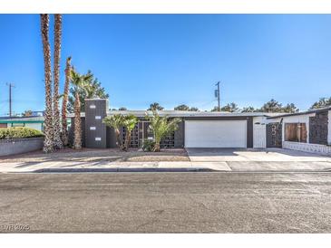 Charming single-story home featuring a modern architectural style and manicured front yard with desert landscaping at 3809 San Angelo Ave, Las Vegas, NV 89102