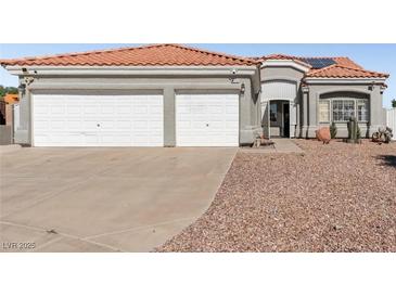 Two-story house with a three-car garage and desert landscaping at 4210 Night Star St, Las Vegas, NV 89147