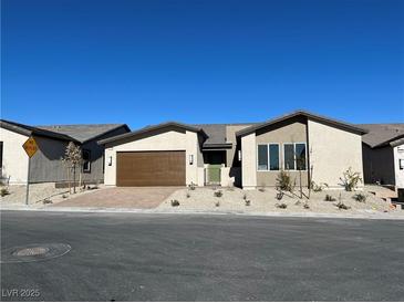 Single-story home with brown garage door and desert landscaping at 5012 Notting Hill Ave, Las Vegas, NV 89139