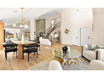 Bright dining room with modern light fixture and hardwood floors at 5201 Rim View Ln, Las Vegas, NV 89130