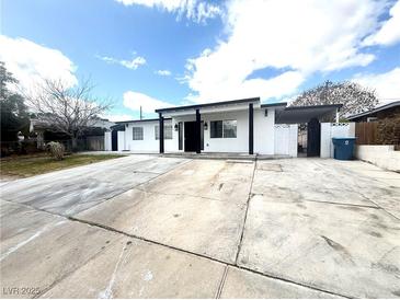 Charming home with a black and white exterior and a spacious driveway at 619 Brush St, Las Vegas, NV 89107