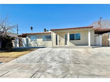 Charming single story home with large front windows and covered entry way at 619 Brush St, Las Vegas, NV 89107