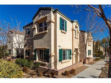 Two-story house with green shutters and a landscaped yard at 7453 Vital Ct, Las Vegas, NV 89149