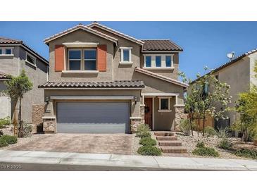 Two-story house with gray garage door, orange accents, and landscaped yard at 10640 Skye Scout Ave, Las Vegas, NV 89166