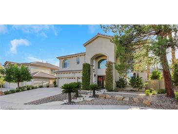 Two-story house with a three-car garage, landscaping, and a large front yard at 10779 Crown Ct, Las Vegas, NV 89141