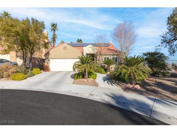 Single-story home with a two-car garage, landscaped yard, and solar panels at 1715 Mesquite Ct, Henderson, NV 89014