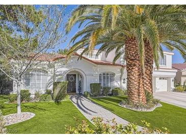 Two-story house with red tile roof, landscaping, and palm trees at 2000 Catalina Marie Ave, Henderson, NV 89074