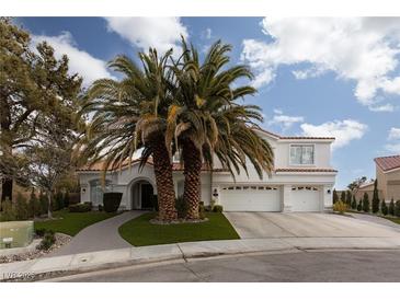 Two-story house with white exterior, palm trees, and a three-car garage at 2000 Catalina Marie Ave, Henderson, NV 89074