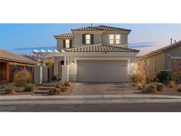 Two-story house with a beige facade and a two-car garage at 2124 Danzinger Pl, Henderson, NV 89044