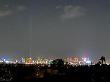 Nighttime view of the city skyline, showcasing bright lights and architectural beauty in a desirable urban setting at 2255 Potter Lake Ave, Henderson, NV 89052