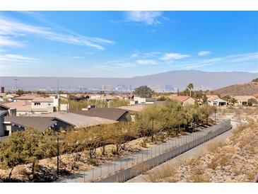 Expansive city view from a neighborhood with desert landscaping and a scenic walking path at 2255 Potter Lake Ave, Henderson, NV 89052