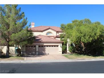 Two-story house with three-car garage and mature landscaping at 272 Arbour Garden Ave, Las Vegas, NV 89148