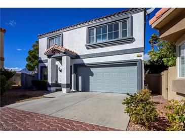 Two-story home showcasing desert landscaping, a gray color scheme, and a two-car garage at 3335 Cheltenham St, Las Vegas, NV 89129