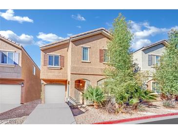 Two-story house with attached garage and landscaped front yard at 4151 San Cuervo Way, Las Vegas, NV 89115