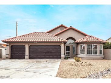 Single-story house with a two-car garage and Spanish tile roof at 4417 Socrates St, North Las Vegas, NV 89031