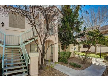 Two-story building with light-pink exterior, stairs, and landscaping at 4805 S Torrey Pines Dr # 201, Las Vegas, NV 89103