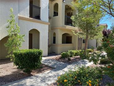 Attractive building exterior with landscaped grounds and walkway at 50 Aura De Blanco St # 13103, Henderson, NV 89074